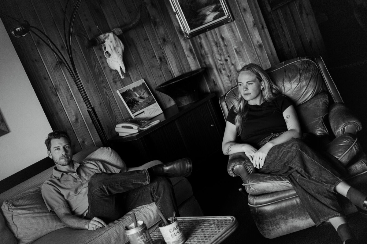 Black and white portrait of Salt in a dark panelled room.